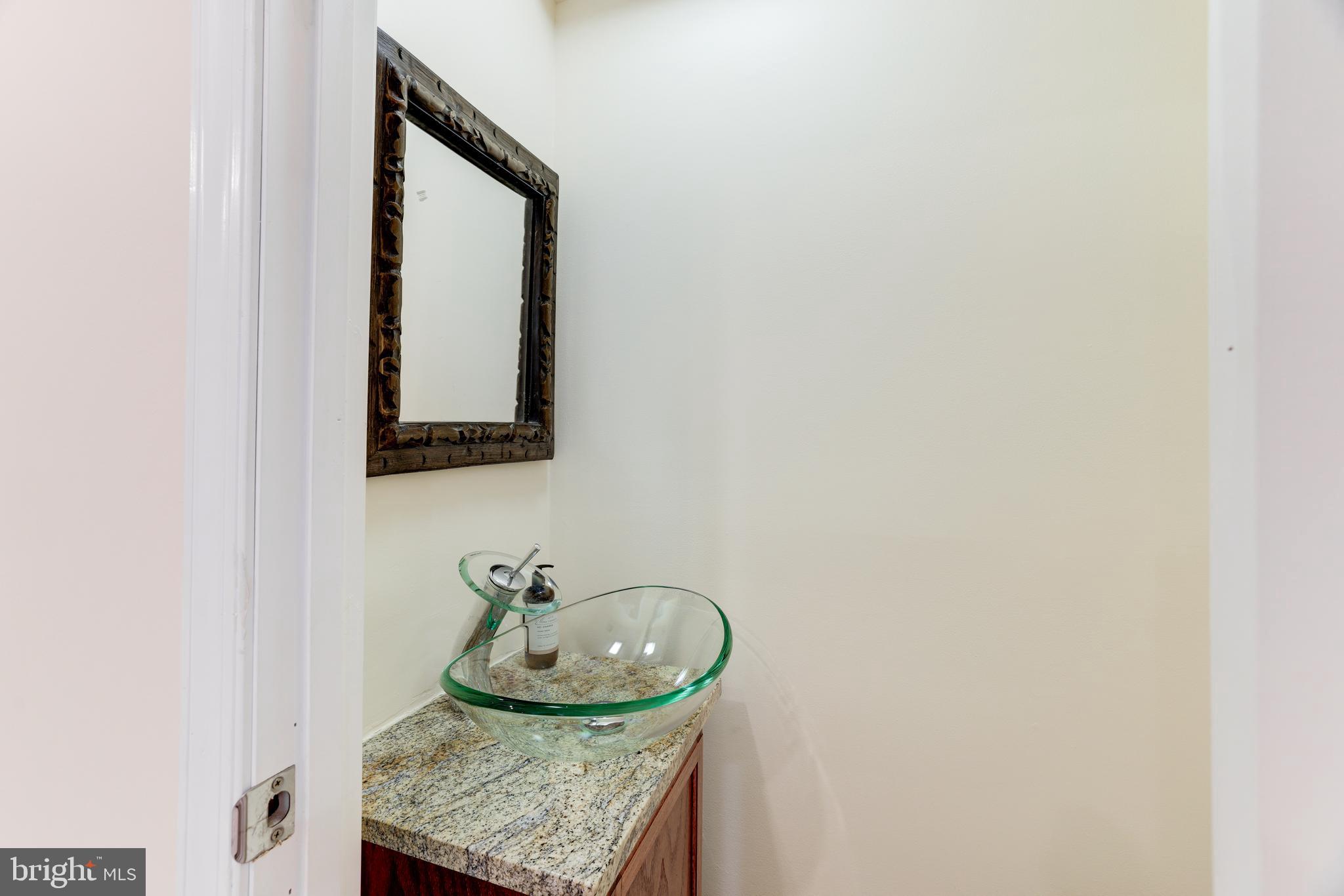 11102 Saffold Way Reston, VA 20190 - Photo 17 of 27 a bathroom with a granite countertop sink and a mirror