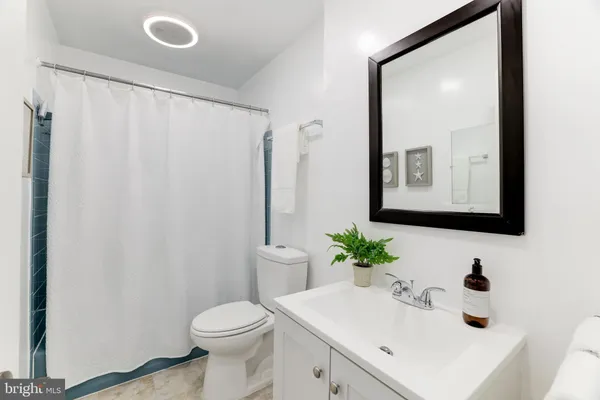 a bathroom with a sink toilet and mirror