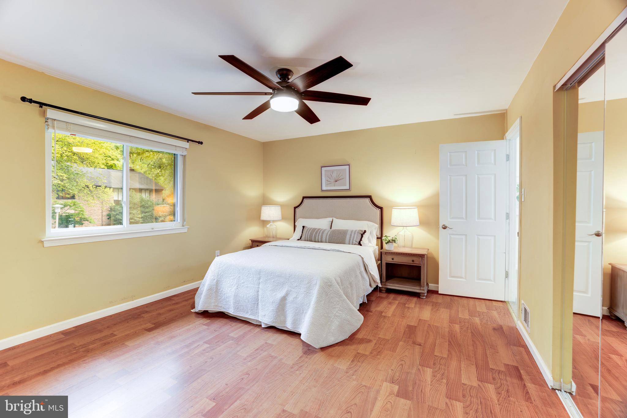 11102 Saffold Way Reston, VA 20190 - Photo 23 of 27 a bedroom with a bed and wooden floor