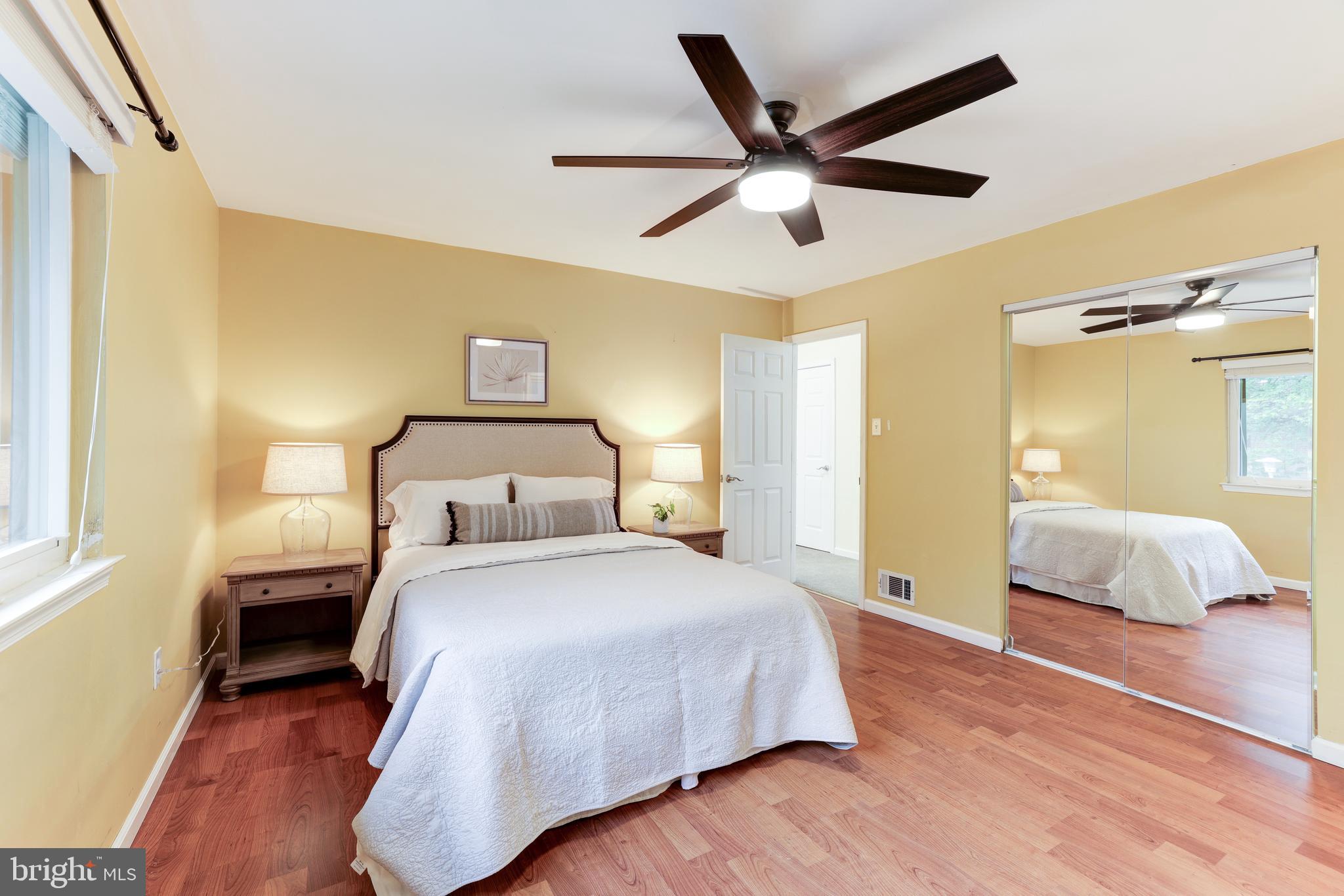 11102 Saffold Way Reston, VA 20190 - Photo 24 of 27 a bedroom with a bed and a ceiling fan