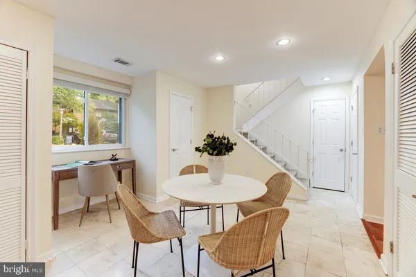 a dining room with furniture and window