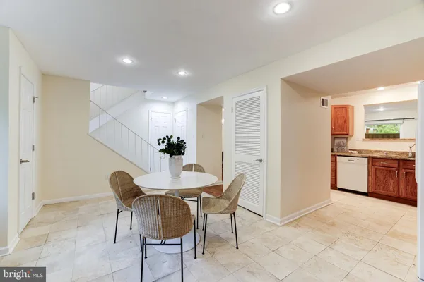 a view of a dining room with furniture and a chandelier