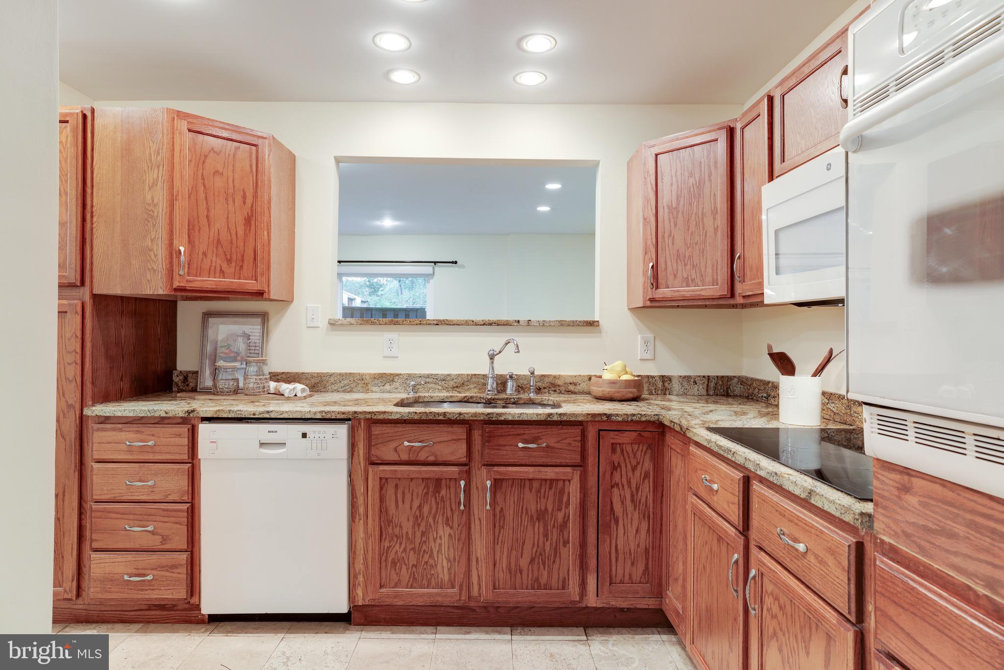 11102 Saffold Way Reston, VA 20190 - Photo 8 of 27 a kitchen with granite countertop a sink and cabinets