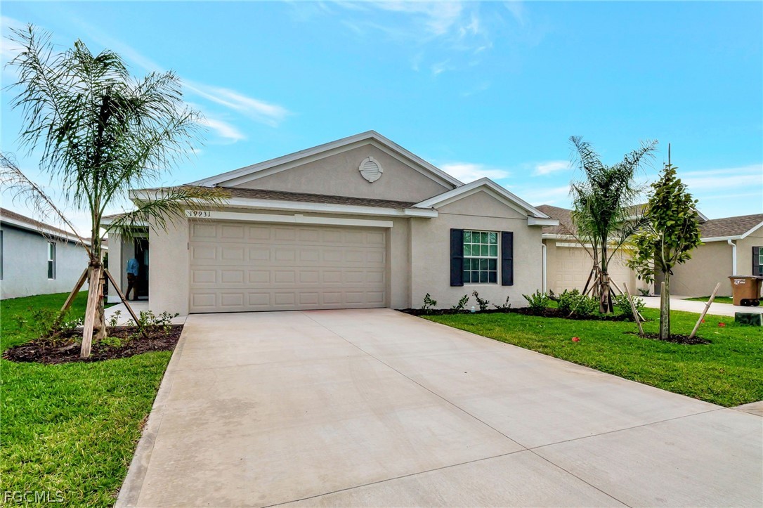 19931 Green Pasture Road Lehigh Acres, FL 33974 - Photo 1 of 19 a front view of a house with garden