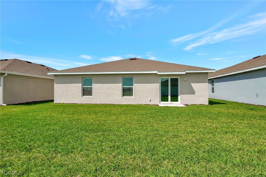19931 Green Pasture Road Lehigh Acres, FL 33974 - Photo 19 of 19 a view of a house with a backyard
