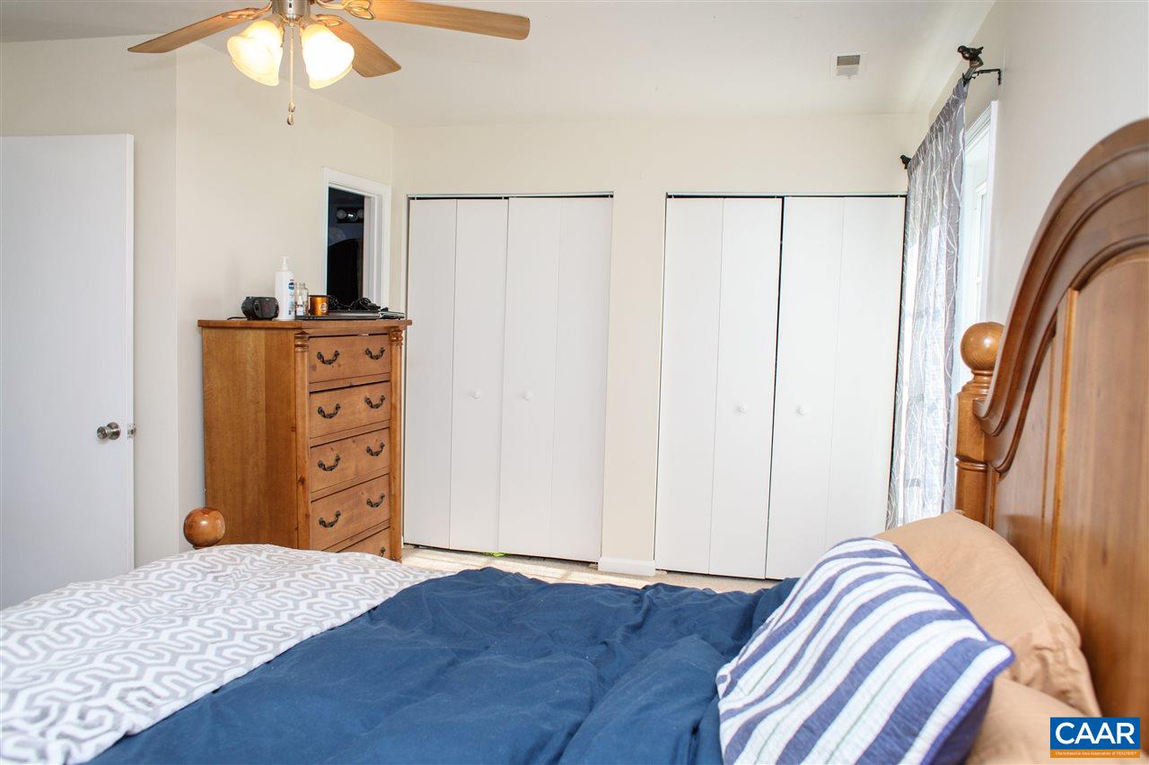 207 West Daffodil Road Ruckersville, VA 22968 - Photo 14 of 21 a bedroom with a bed and a chandelier
