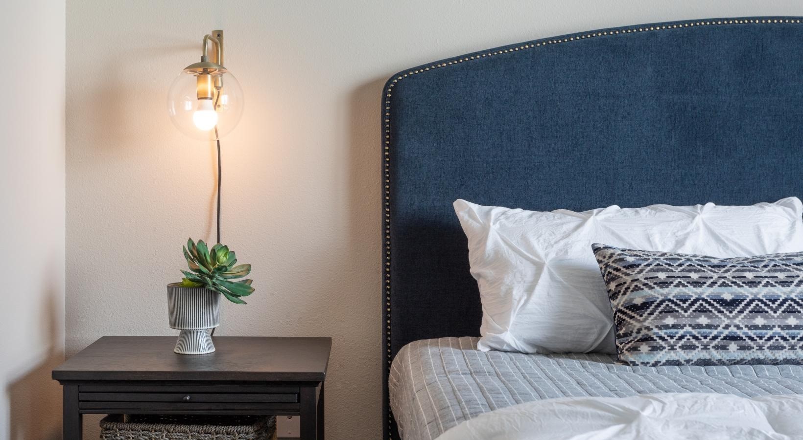 19770 Clay Road, Unit 99302 Katy, TX 77449 - Photo 11 of 35 a bed sitting in a bedroom next to a lamp