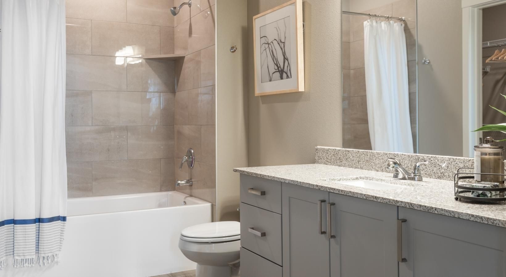 19770 Clay Road, Unit 99302 Katy, TX 77449 - Photo 13 of 35 a bathroom with a sink a toilet and shower