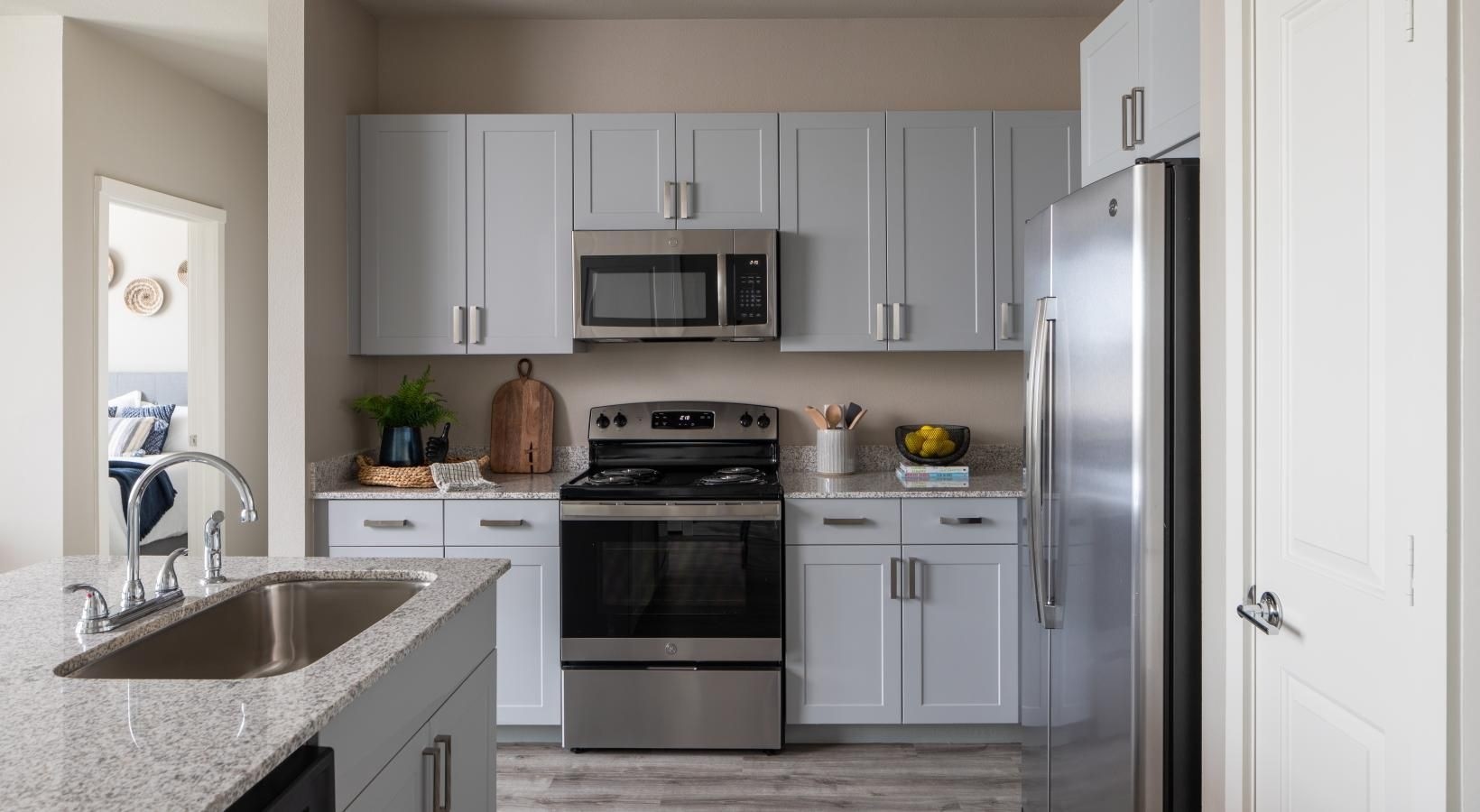 19770 Clay Road, Unit 99302 Katy, TX 77449 - Photo 7 of 35 a kitchen with stainless steel appliances granite countertop a refrigerator sink and stove