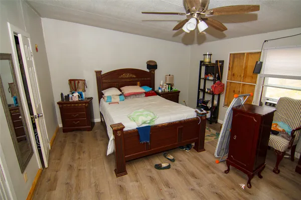 a bedroom with a bed and a mirror