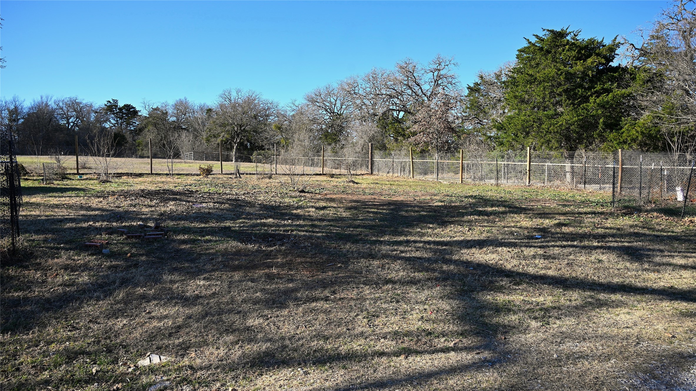 155 Arbuckle Road Elgin, TX 78621 - Photo 12 of 35 a view of a yard with wooden fence