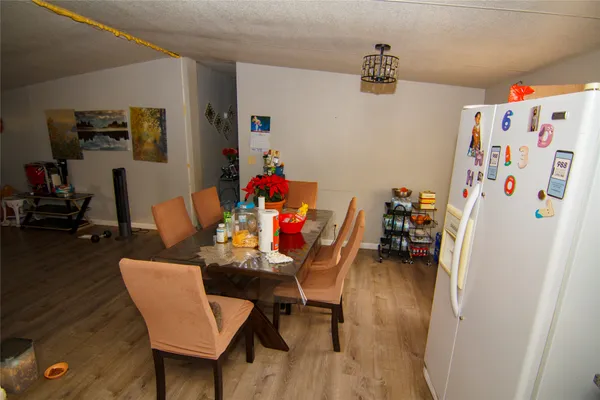 a dining room with furniture and wooden floor