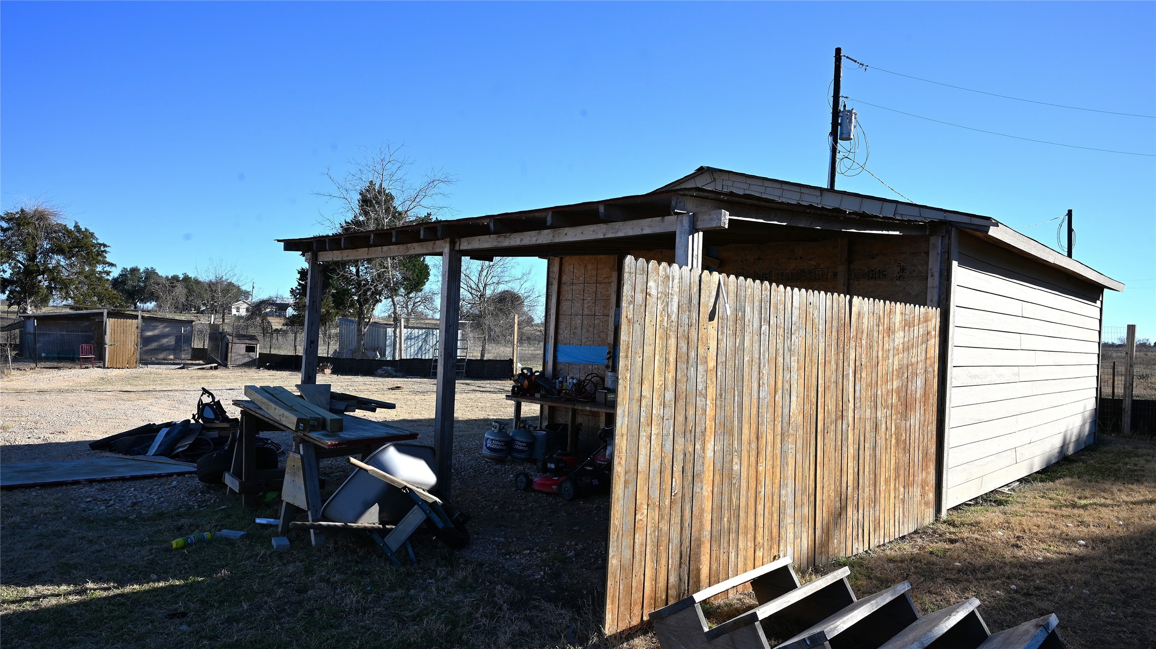 155 Arbuckle Road Elgin, TX 78621 - Photo 20 of 35 a view of backyard with a table and chairs under an umbrella