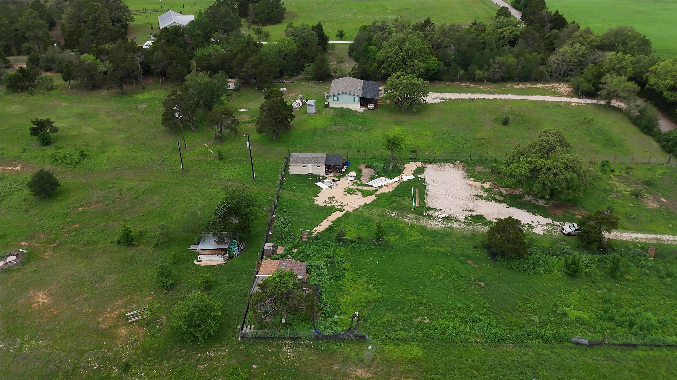 155 Arbuckle Road Elgin, TX 78621 - Photo 26 of 35 a view of a lake with huge green field and trees