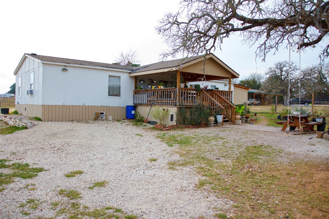 155 Arbuckle Road Elgin, TX 78621 - Photo 3 of 16 Rear view of house featuring a deck, stairs, a patio area, and cooling unit