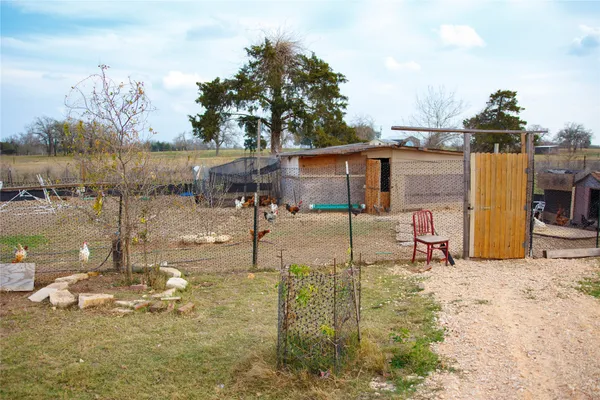 a backyard of a house with table and chairs