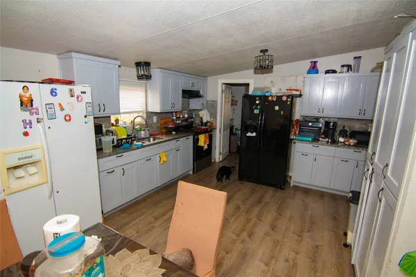 a kitchen with refrigerator and window