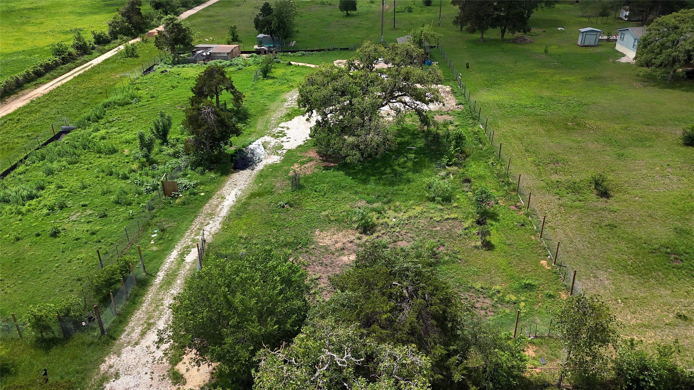 155 Arbuckle Road Elgin, TX 78621 - Photo 10 of 35 a view of a garden with a lake