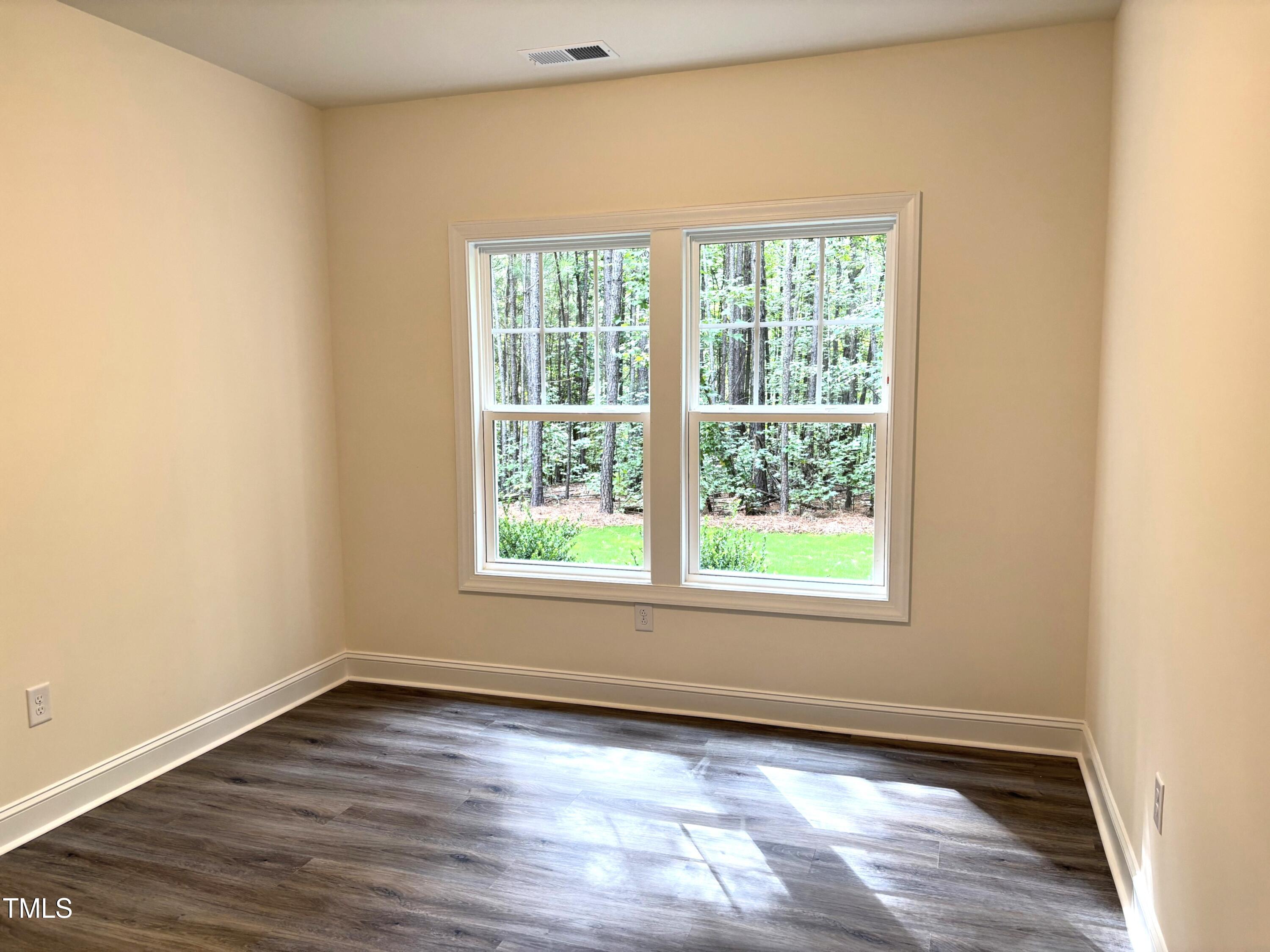 602 Weather Ridge Lane, Unit 21 Cary, NC 27513 - Photo 10 of 19 an empty room with wooden floor and windows