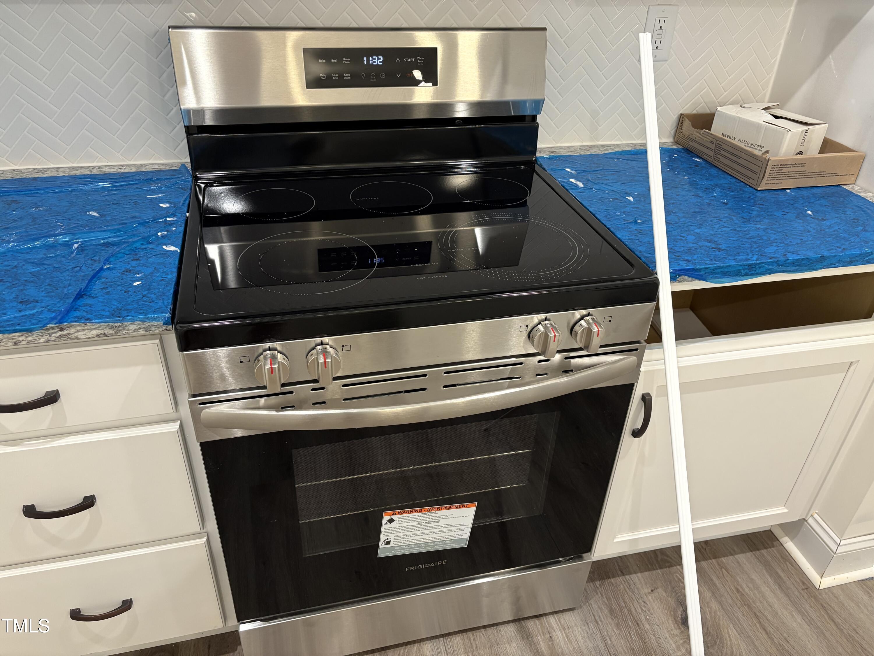 602 Weather Ridge Lane, Unit 21 Cary, NC 27513 - Photo 13 of 19 a stove top oven sitting inside of a kitchen