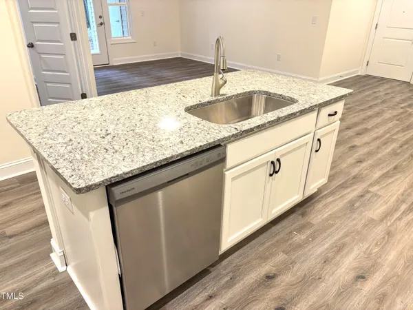 a kitchen with stainless steel appliances granite countertop a sink stove and microwave