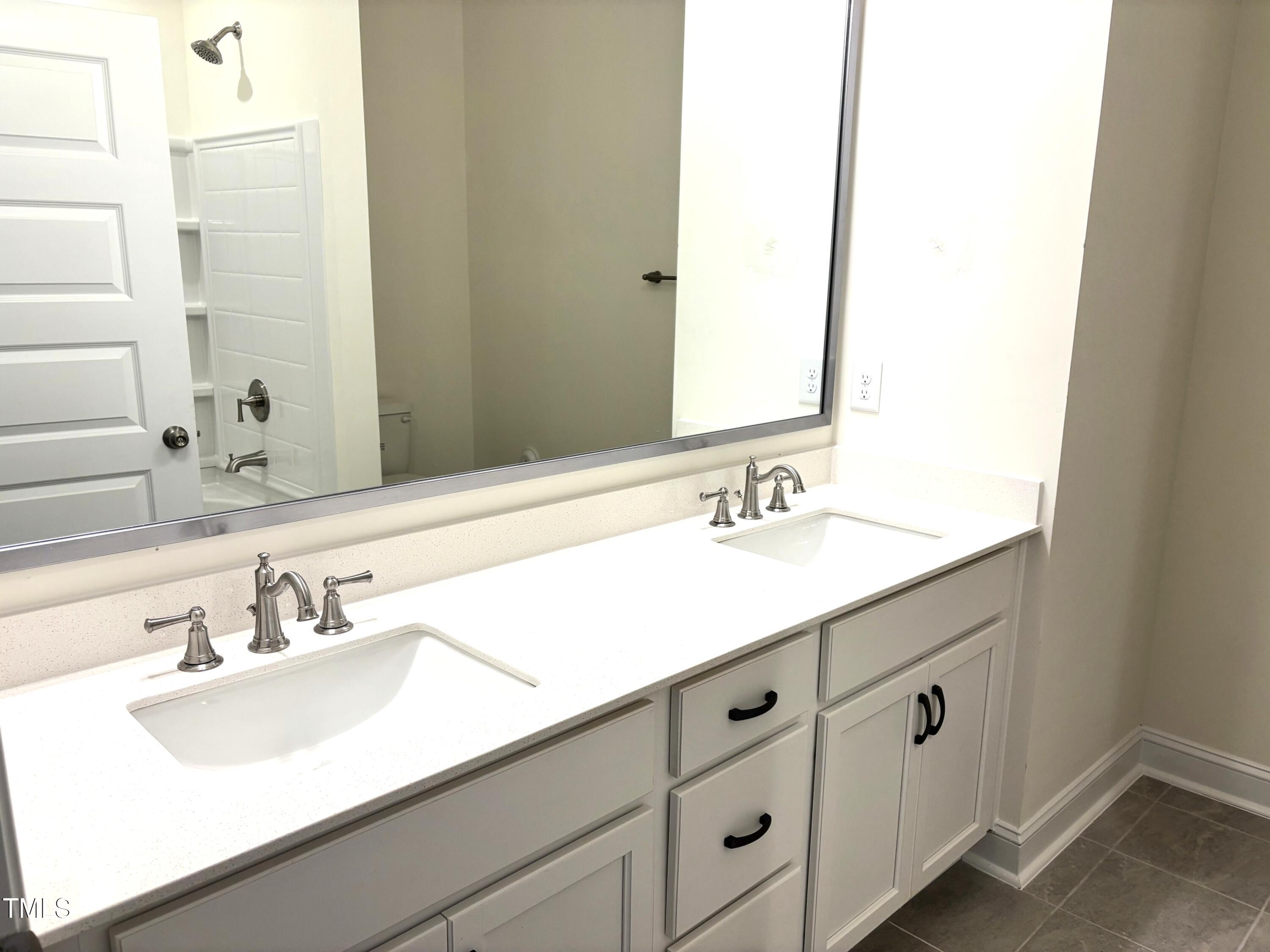 602 Weather Ridge Lane, Unit 21 Cary, NC 27513 - Photo 8 of 19 a bathroom with double sink and a mirror