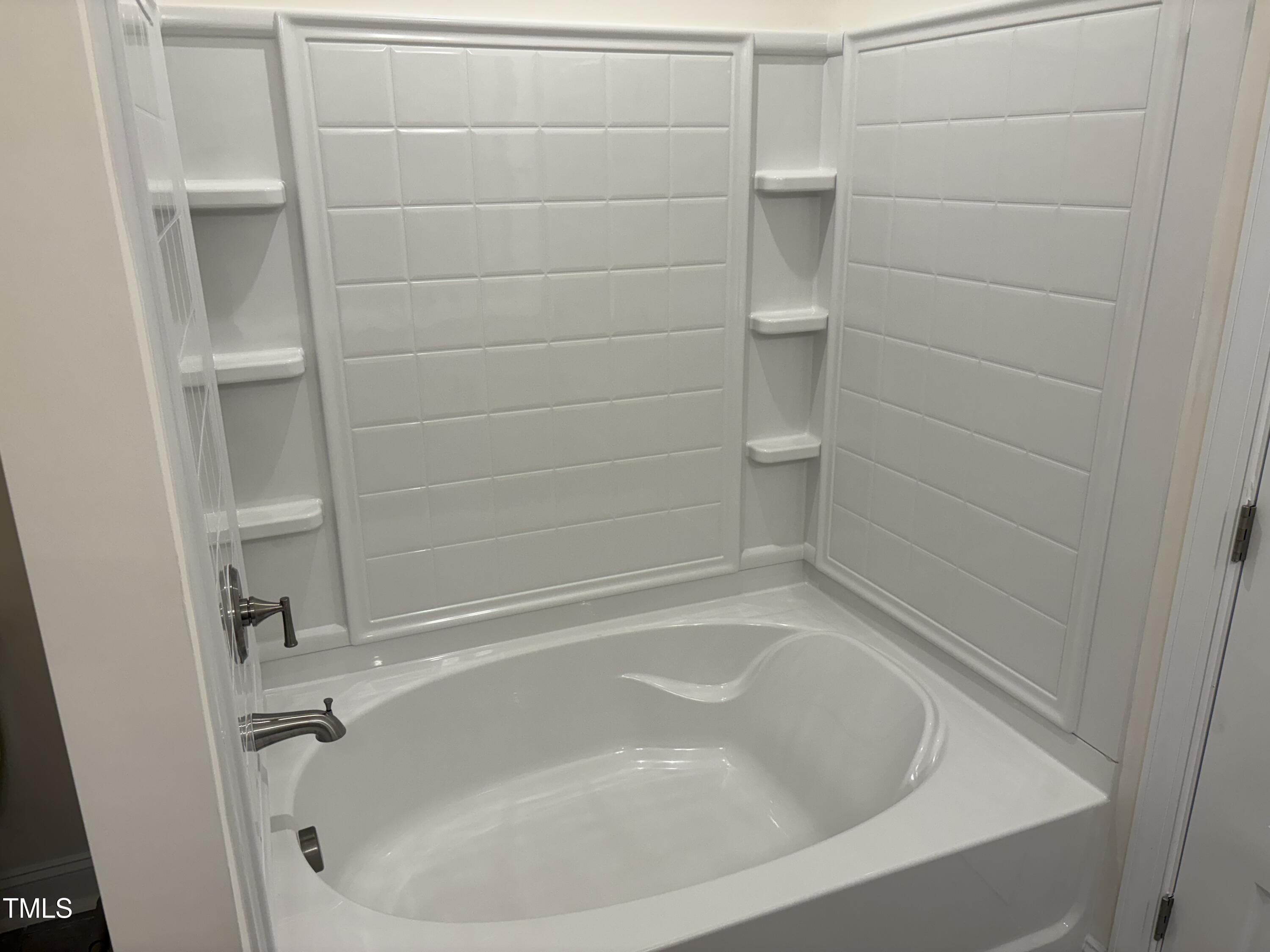 602 Weather Ridge Lane, Unit 21 Cary, NC 27513 - Photo 9 of 19 a close up of a bathtub in a bathroom