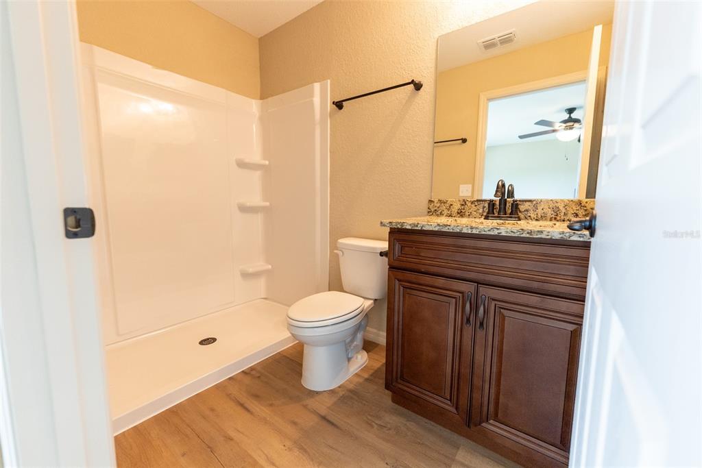 23855 Southwest White Sands Road Dunnellon, FL 34431 - Photo 15 of 42 a bathroom with a granite countertop sink toilet and shower