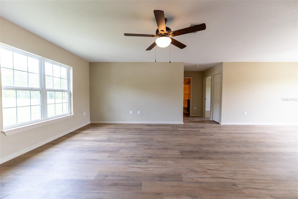 23855 Southwest White Sands Road Dunnellon, FL 34431 - Photo 3 of 42 wooden floor in an empty room with a window