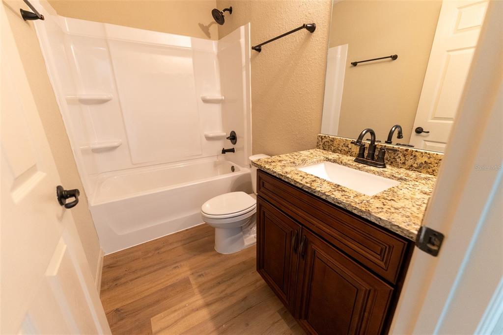 23855 Southwest White Sands Road Dunnellon, FL 34431 - Photo 38 of 42 a bathroom with a granite countertop sink toilet and shower