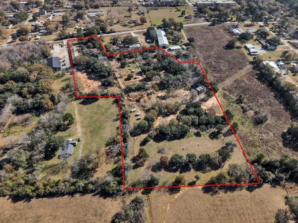 an aerial view of a house with a yard and garden