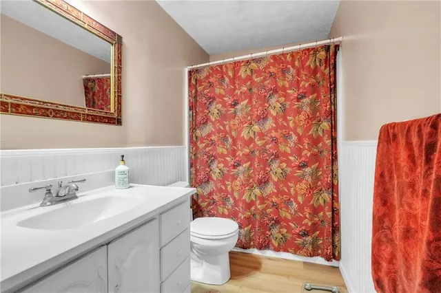 a bathroom with a sink toilet and shower