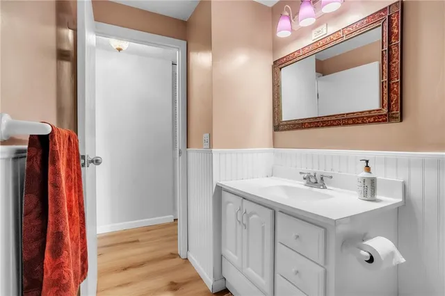 a bathroom with a sink vanity and a mirror