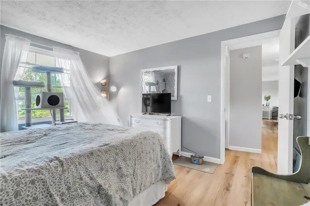 a bed room with a bed and a view of living room