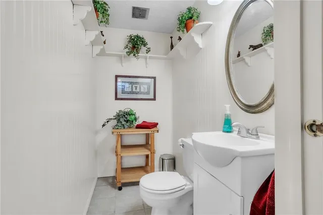 a bathroom with a sink mirror and toilet