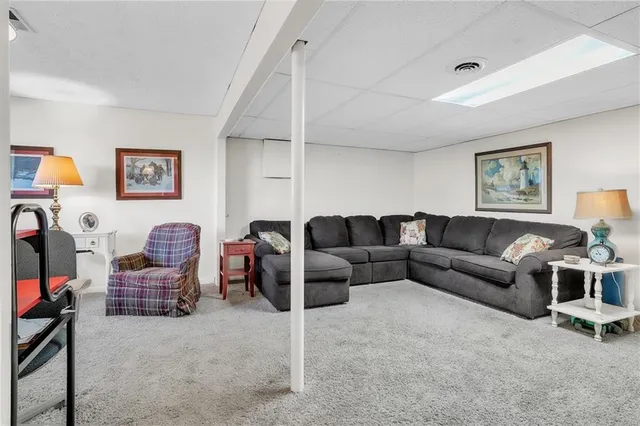 a living room with furniture a couch and painting on the wall