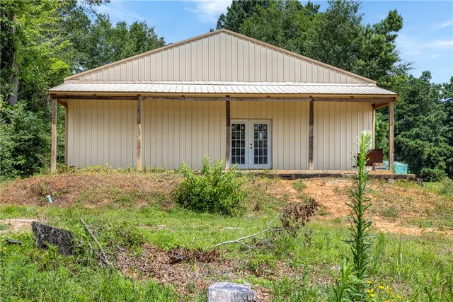 a view of a white house with garden