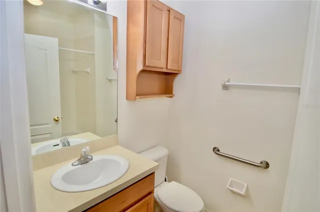 a bathroom with a sink toilet and a mirror