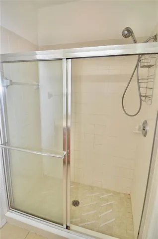 a bathroom with a glass shower door