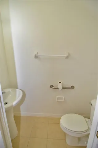 a white toilet sitting next to a bathroom sink