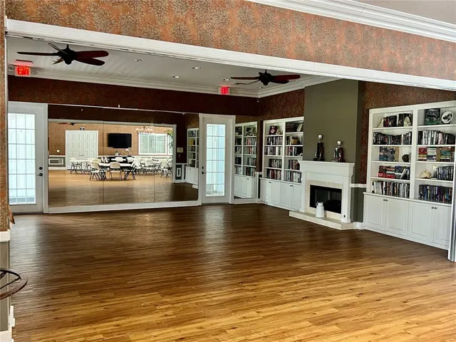 a view of a kitchen with stainless steel appliances granite countertop a stove and cabinets