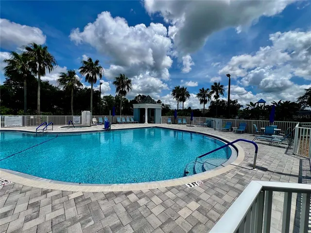 a view of a swimming pool with outdoor seating