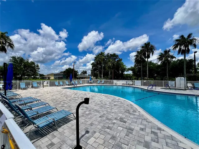 a view of a swimming pool with lounge chairs