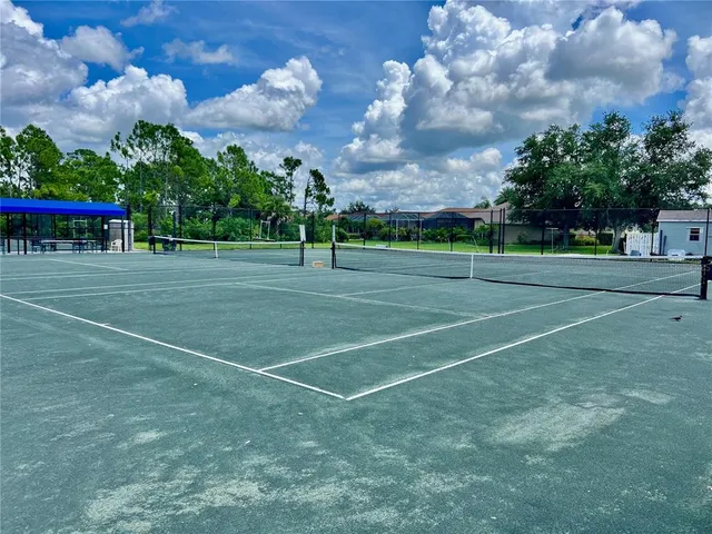 a view of a playground ground and trees
