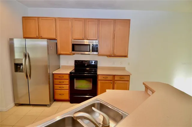 a kitchen with a refrigerator stove and microwave