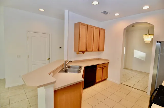 a kitchen with stainless steel appliances granite countertop a sink and a refrigerator