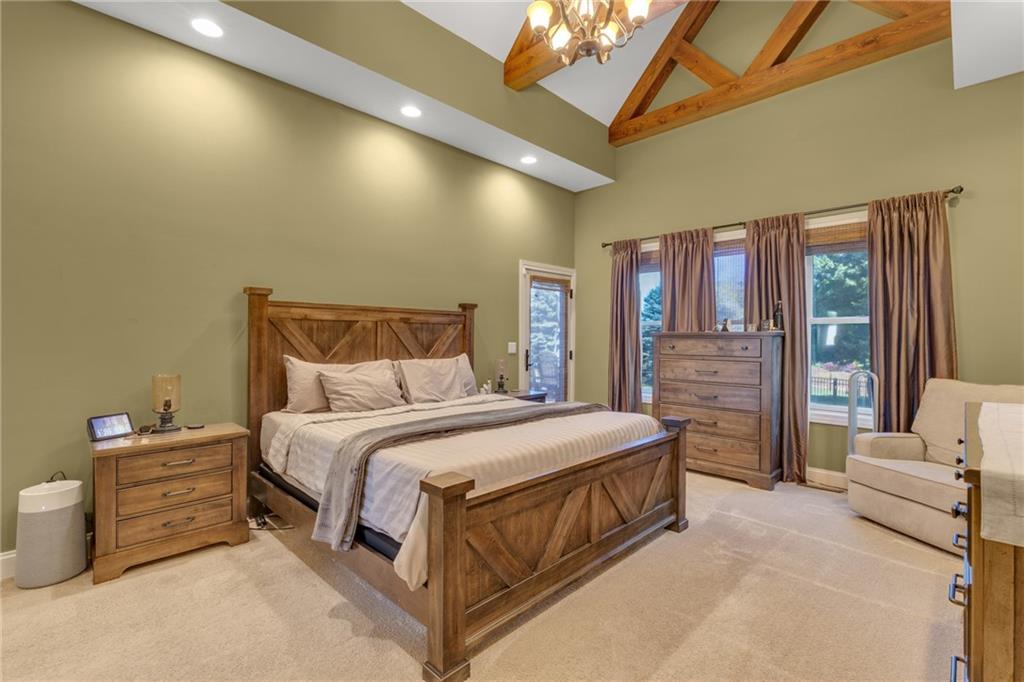 125 James Drive Beaver, PA 15009 - Photo 4 of 40 a spacious bedroom with a bed a couch and a chandelier