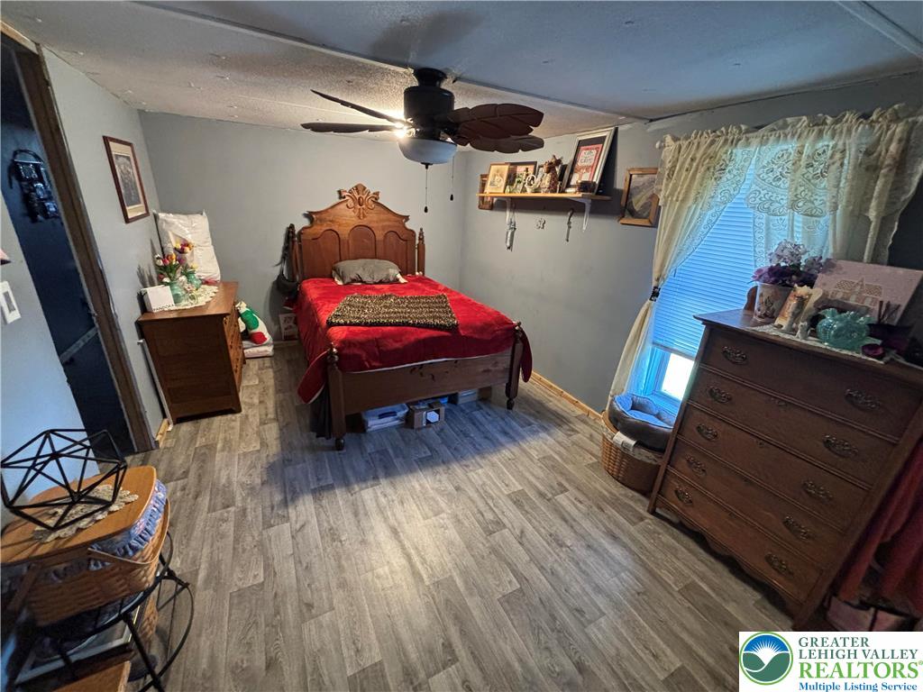 3 Tribe Lane Wind Gap, PA 18091 - Photo 4 of 6 a bedroom with furniture and a wooden floor