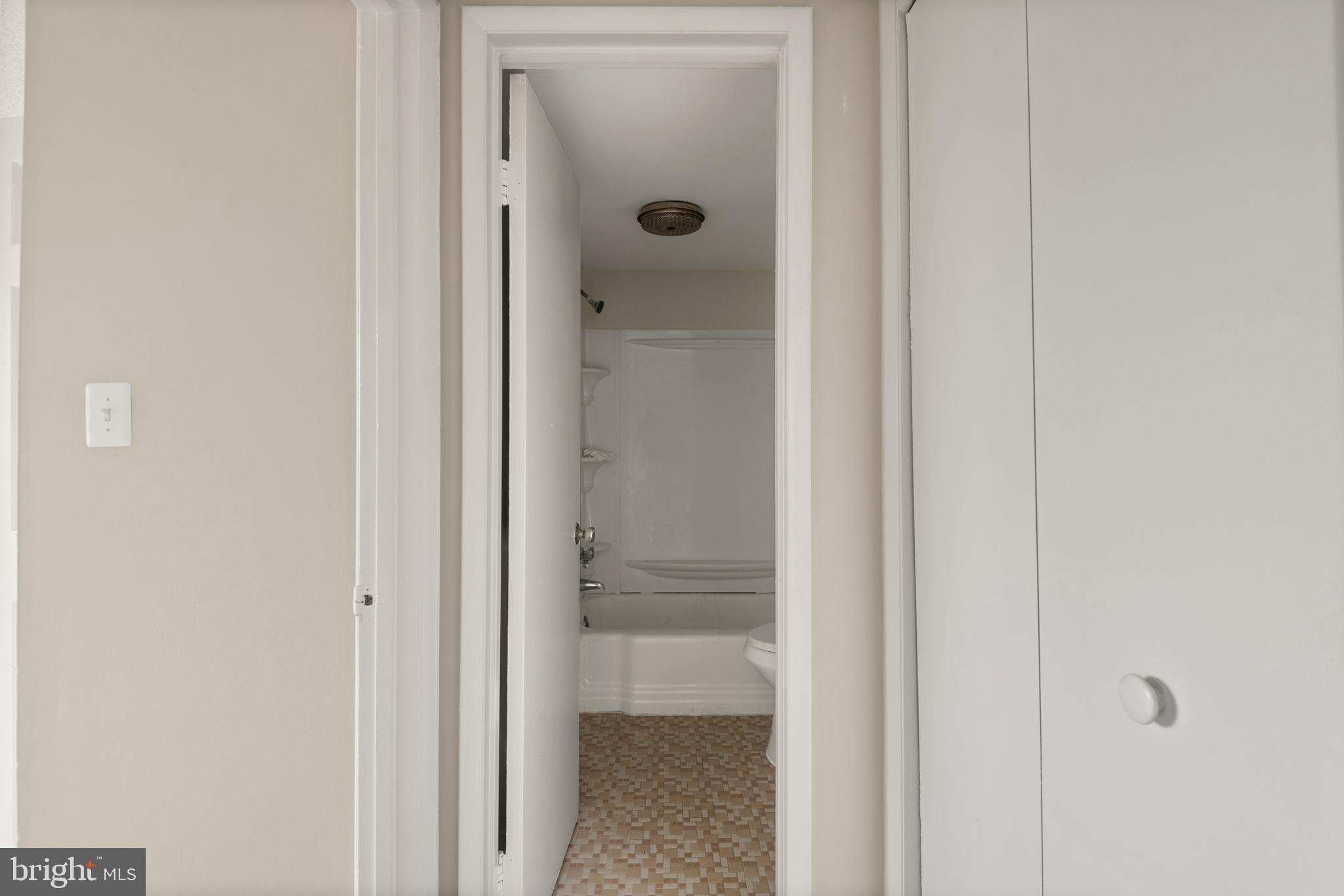 1824 Metzerott Road, Unit 303 Adelphi, MD 20783 - Photo 16 of 28 a bathroom with a glass shower door