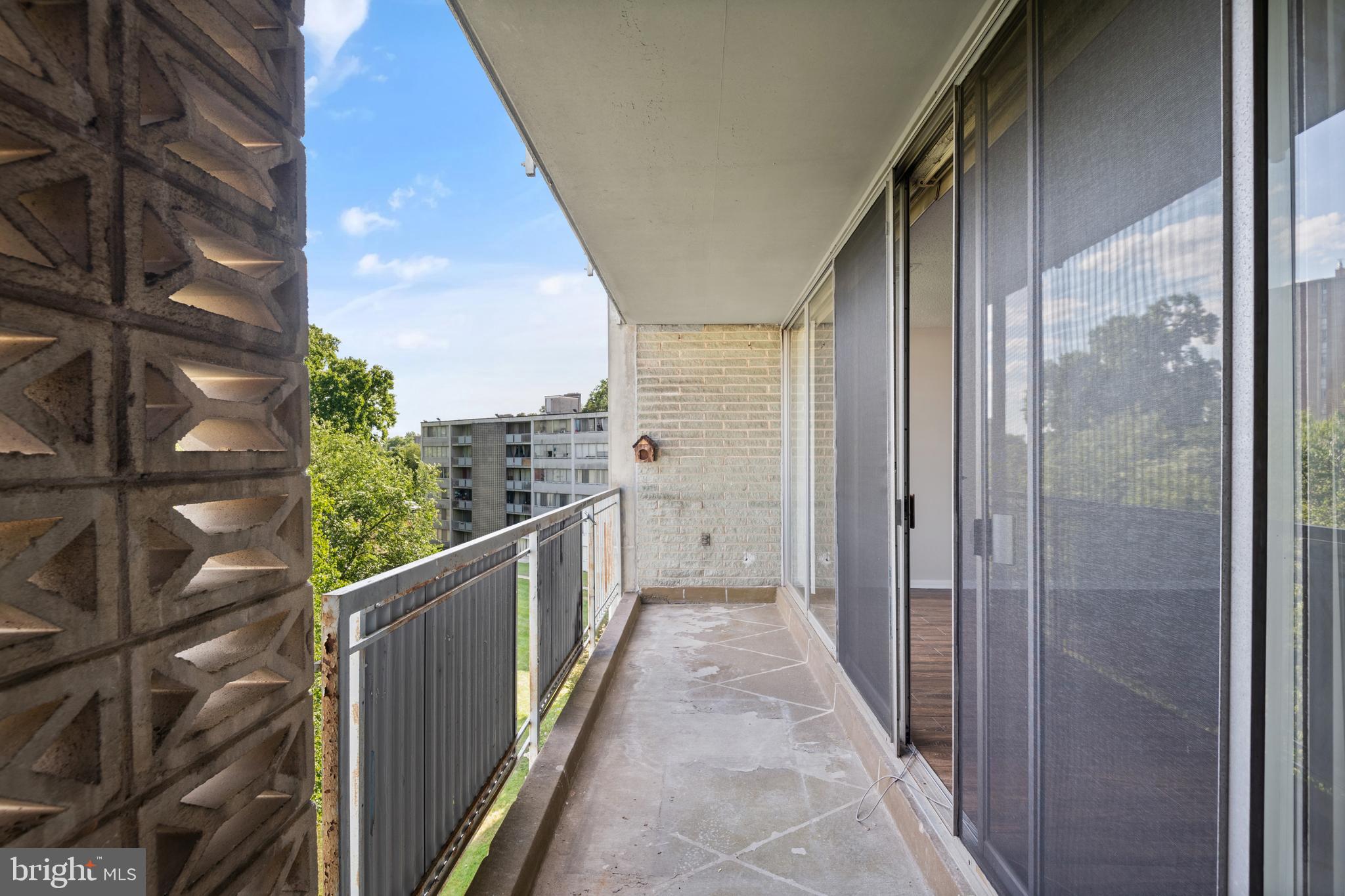 1824 Metzerott Road, Unit 303 Adelphi, MD 20783 - Photo 24 of 28 a view of a balcony with wooden floor and fence